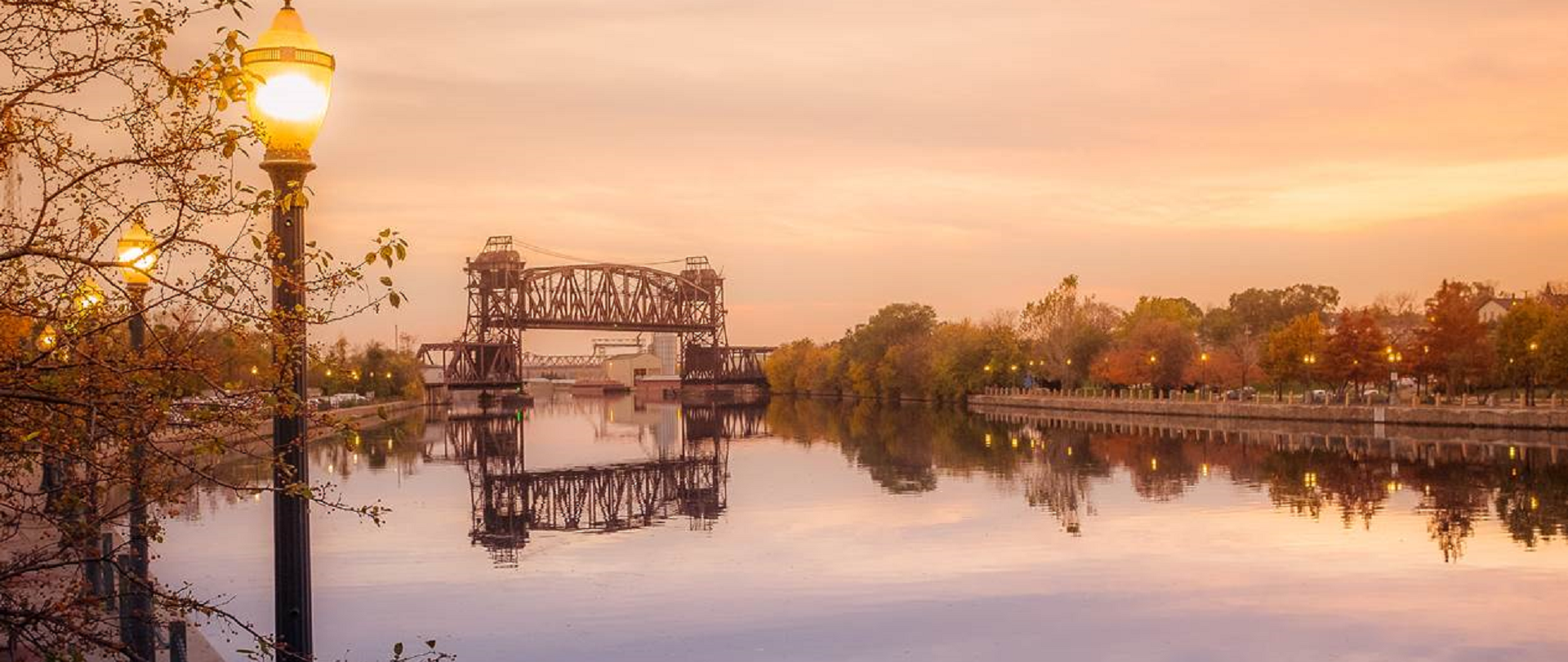 Sunset over the Des Plaines river and train drawbridge